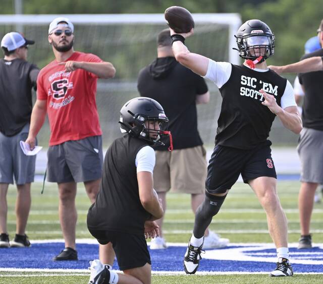 Southmoreland head football coach Dustin Shoaf looks on as quarterback Dawson Wolfe throws during the WCCA 7-on-7 tournament July 17, 2025, at Hempfield Area High School.