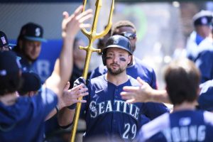 Seattle’s Cal Raleigh is greeted by teammates after hitting a home run during the seventh inning against the Angels on July 27. Raleigh leads the majors with 42 homers.