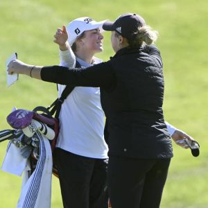 Peters Township’s Ellie Benson hugs Elizabeth Forward’s Mya Morgan after their rounds at the WPIAL Class 3A team championship Oct. 10, 2024, at Cedarbrook in Rostraver.
