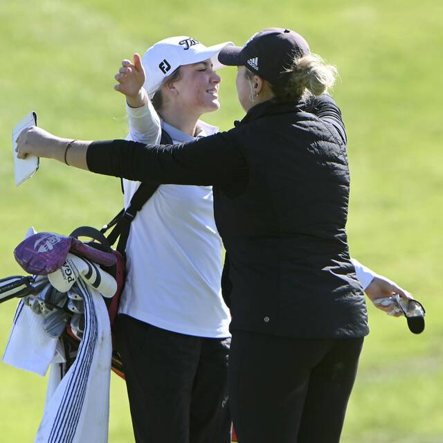 Peters Township’s Ellie Benson hugs Elizabeth Forward’s Mya Morgan after their rounds at the WPIAL Class 3A team championship Oct. 10, 2024, at Cedarbrook in Rostraver.