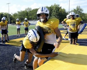 South Allegheny’s Drew Cook takes a hit from Kymair Brown during tackling drills at practice on Tuesday, Aug. 12, 2025, at Gladiators Stadium.