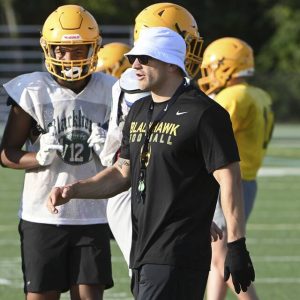 Blackhawk head coach Jake Wickline works with his team during practice in Chippewa.