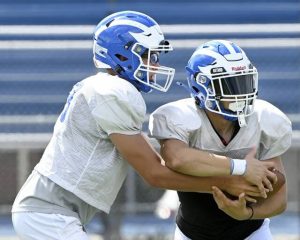 Ellwood City’s Ricky Cureton takes a handoff from quarterback Tyler Smiley during practice on Wednesday, Aug. 13, 2025, in Ellwood City.