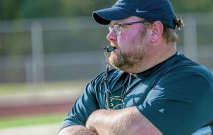 Kiski Area coach Colyn Haugh works with his varsity squad during the first day of football practice Monday.