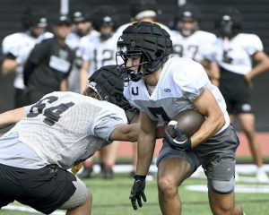 Upper St. Clair’s Dante Coury carries during offensive drills at practice on Wednesday, Aug. 6, 2025, at Panther Stadium in USC.