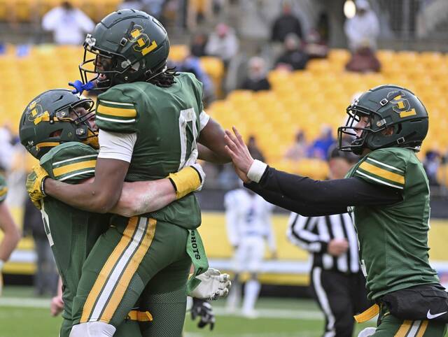 Seton LaSalle wide receiver Khalil Taylor (0) celebrates with teammates Will Martin and Michael Pastirik after Taylor scored a touchdown in the 2024 WPIAL Class 2A final at Acrisure Stadium.