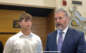 Anthony Smith (left) looks at attorney Steve Toprani while addressing the media on Tuesday at the Westmoreland County courthouse in Greensburg.