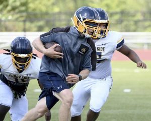 Shady Side Academy head coach Andrew Geisler works out with his team during practice on Tuesday, Aug. 12, 2025, in Fox Chapel.