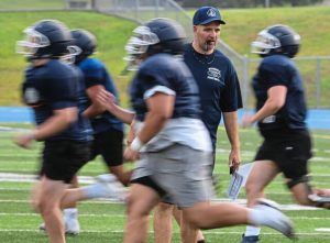 Burrell coach Dom Girardi looks on as players run sprints during practice on Thursday, Aug. 7, 2025, at Burrell High School.