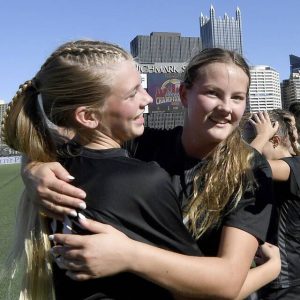 Quaker Valley’s Lily Baker (left) hugs Annabel Miko after defeating Burrell, 2-1, in the WPIAL Class 2A championship game Nov. 2, 2024, at Highmark Stadium.