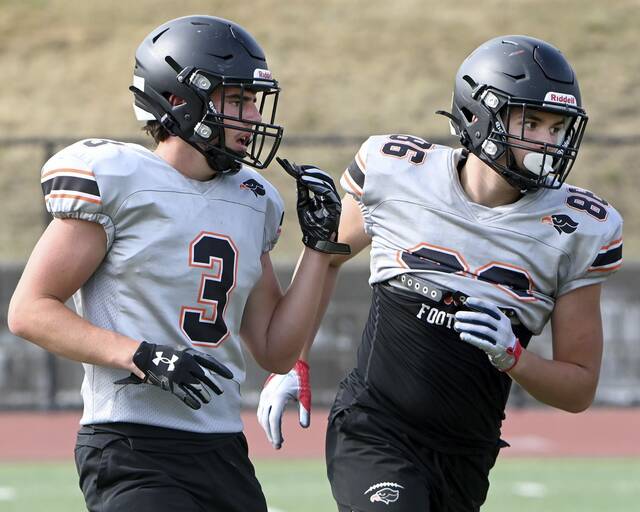 Bethel Park’s Charlie Simmons (left) works out with Jovian Smith during practice Aug. 6.