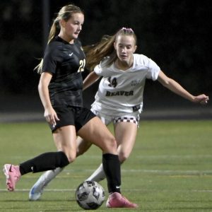 Quaker Valley’s Annabel Miko sets up the go-ahead goal next to Beaver’s Madeline Porto on Oct. 9, 2024, in Leetsdale.