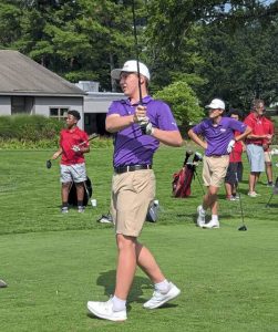 Senior Tyler Pastor follows a tee shot, while fellow senior Dany Caruso (right) looks on during a 2024 match at Green Oaks Golf Club.