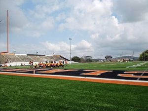 Clairton coach Wayne Wade and staff assemble players as morning practice ended Aug. 13, 2025, at Tyler Boyd Stadium.