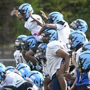 Woodland Hills players try to block a kick during special teams practice on Aug. 5 at the Wolvarena.