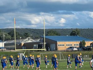 Chestnut Ridge, the Allegheny Mountain's westernmost elevation in Pennsylvania, separates the Derry Area and Ligonier Valley school districts and serves as a backdrop for Derry players during pregame warmups for the annual "Riot on the Ridge" high school football game featuring the two Westmoreland County rivals on Friday, Aug. 22, 2025, in Derry Township.