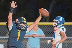 Apollo-Ridge quarterback Alex Clawson celebrates after scoring the winning touchdown late in the fourth quarter against Leechburg on Friday.