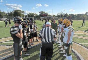 Captains from Keystone Oaks and Deer Lakes meet at midfield before their game Friday, Aug. 22, 2025.