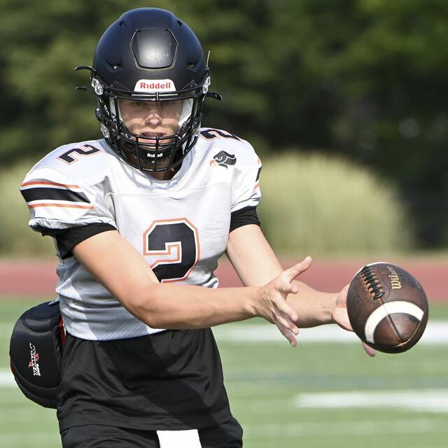 Bethel Park quarterback Evan Devine takes a snap during practice earlier this month.