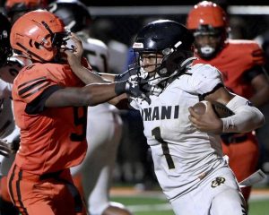 Imani Christian’s Gabe Jenkins stiff-arms Clairton’s Darren Pinson during their game Friday, Aug. 22, 2025, at Tyler Boyd Stadium.