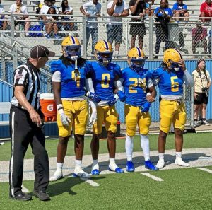 Westinghouse captains head to midfield for the coin toss before their game against Steel Valley on Saturday at the Wolvarena.