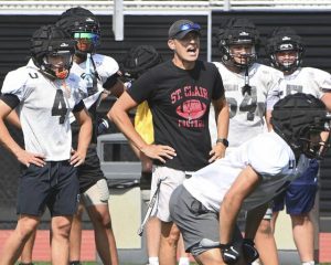 Upper St. Clair coach Mike Junko works with his team during practice Aug. 6.