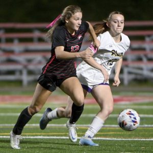 Fox Chapel’s Emily McKee (left) works past Plum’s Catie Weiss during their WPIAL Class 3A semifinal Tuesday, Oct. 29, 2024, at Martorelli Stadium in Ross.