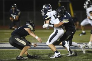 Kiski Area’s Collin Peterson works to take down Knoch’s Owen Layhew last Friday.