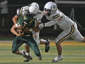 Norwin’s Jose Lenart and Gil Algeri sack Penn-Trafford’s Nate Desmond last Friday.