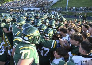 Youth football players get the Penn-Trafford football team ready to play Norwin last Friday.