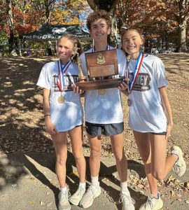 Quaker Valley’s Cecilia, Jonah and Lucy Montagnese pose after the 2024 WPIAL cross country championships at White Oak Park.