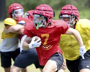 North Catholic’s Logan Schade carries the ball during preseason practice.