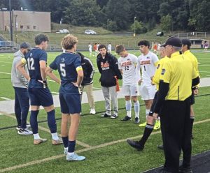 Franklin Regional and Latrobe boys soccer players gather for a pregame meeting with officials Thursday night at Panther Stadium in Murrysville.
