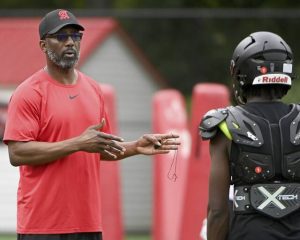 Aliquippa head coach Mike Warfield talks with quarterback Marques Council Jr. on Thursday, July 31, 2025, at Heinz Field in Aliquippa.