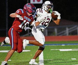 Greensburg Central Catholic’s Samir Crosby pulls in a touchdown pass past Mt. Pleasant’s Robert Hixson on Friday.