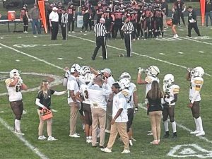 Coaches and players from Greensburg Salem (front) and Ligonier Valley huddle during a timeout in the second quarter Friday.