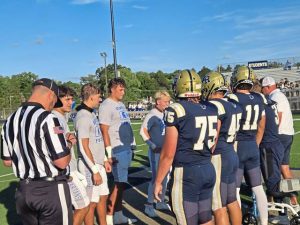 Players from Hempfield and Franklin Regional line up for the coin toss Friday at Franklin Regional.