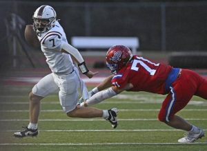 Mt. Pleasants Carter Strayer pressures Greensburg Central Catholic quarterback Bobby Smithnosky on Friday at Mt. Pleasant Area High School.