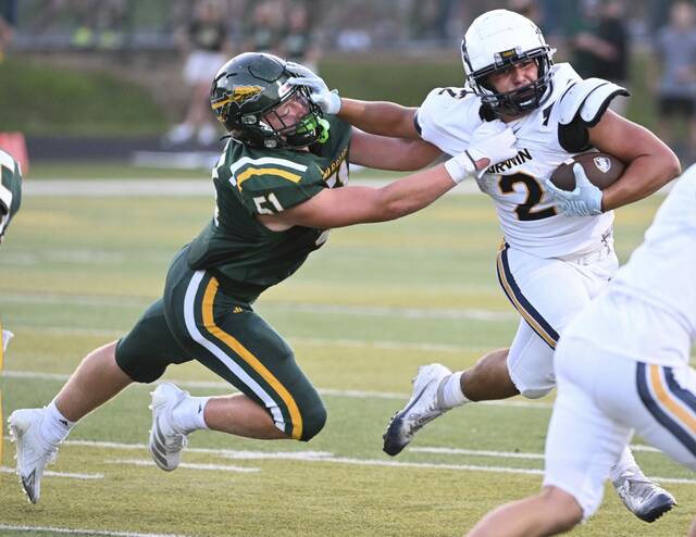 Norwin’s Giovanni Rothrauff stiff-arms Penn Trafford’s Lucah Butler last week. Norwin rose to No. 5 in the Class 6A rankings this week.