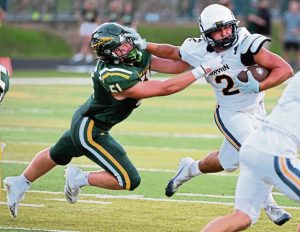 Norwin’s Giovanni Rothrauff stiff-arms Penn Trafford’s Lucah Butler last week. Norwin rose to No. 5 in the Class 6A rankings this week.