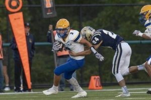 Derry’s Noah Stough (3) is wrapped up by Freeport’s Eli Pwerroz during their game Aug. 29, 2025, at Freeport.