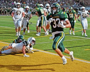 Penn-Trafford’s Landyn Stikkel bounces into the end zone against Norwin on Aug. 22.