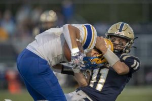 Derry’s Noah Stough is brought down by Freeport’s Drew Ross in the first half last Friday.