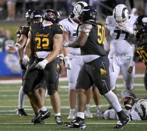 Central Catholic’s Angelo Pugliano (32) celebrates a tackle for loss against Pine-Richland last Friday.