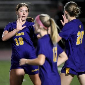 Plum’s Olivia Bigger celebrates with Emily Grubich after Grubich scored during the second half against Franklin Regional on Aug. 25 at Plum.