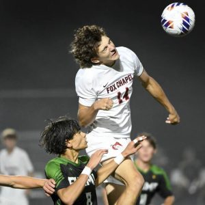 Fox Chapel’s Patrick Levy battles Pine-Richland’s Samuel Beuse for a header in the fog during their game Thursday in Pine. Fox Chapel won, 5-0.
