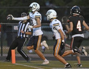 Norwin’s Potter Brozeski stretches the ball into the end zone to score a second-quarter touchdown against Latrobe on Friday.