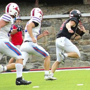 Southmoreland quarterback Dawson Wolfe (15) races down the sideline for a big gain with Laurel Highlands defenders in pursuit during the first quarter Friday at Russ Grimm Stadium. Wolfe scored on a 2-yard run on the next play.