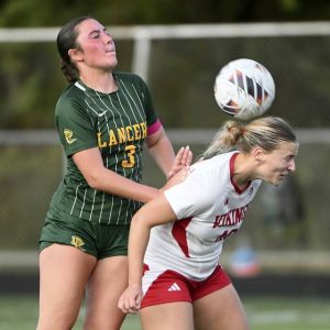 Mt. Pleasant’s Camryn Kapr battles Deer Lakes’ Brooke Cacurak for a header during their game on Monday, Sept. 8, 2025, in West Deer.