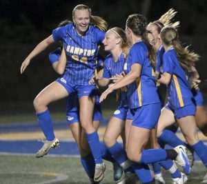 Hampton’s Alexis Bosetti (left) celebrates with teammates after the Talbots scored against Mars on Aug. 27.